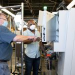 two men looking at a machine