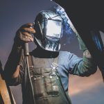 a person wearing an auto darkening welding helmet