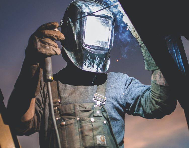 a person wearing an auto darkening welding helmet