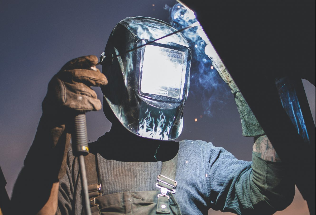 a person wearing an auto darkening welding helmet