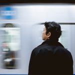 Person standing as subway passes by them quickly.