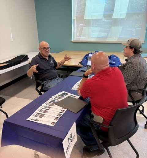 Employer speaking at table at job fair